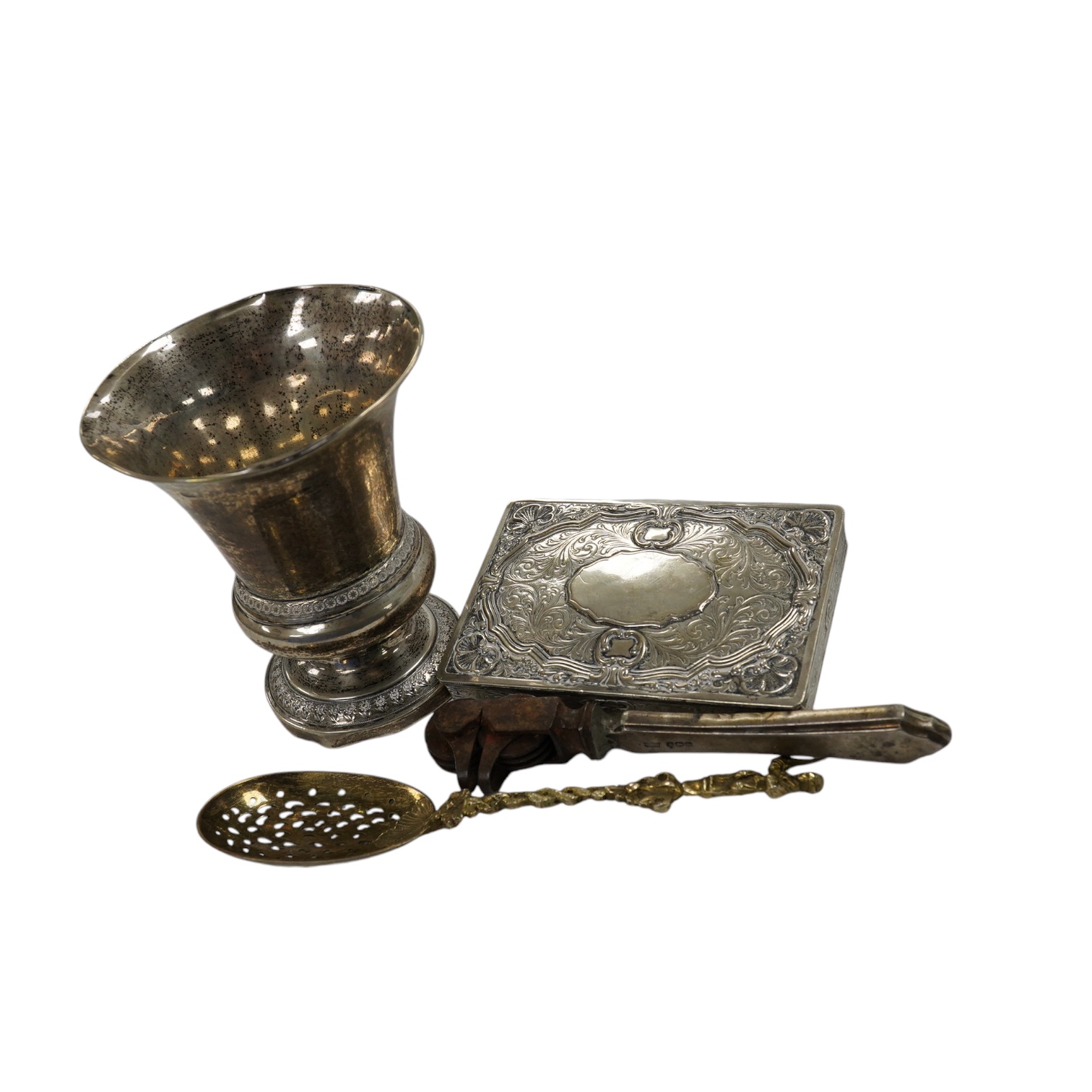 A 19th century Austro Hungarian white metal vase, 11.7cm and other items including a silver gilt spoon, silver stilton scoop, silver match sleeve, silver inlaid glass mats and plated items etc. Condition - poor to fair